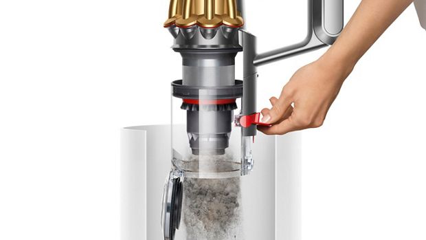 A model emptying the Dyson V12s Detect Slim Submarine Complete wet and dry vacuum bin.