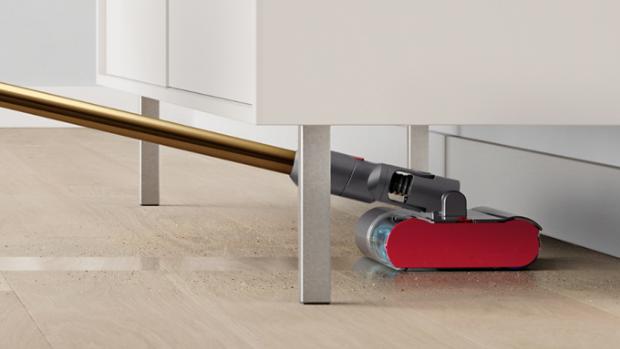 The Dyson V12s Detect Slim Submarine cleans underneath a low cabinet.