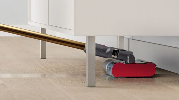 The Dyson V12s Detect Slim Submarine cleans underneath a low cabinet.