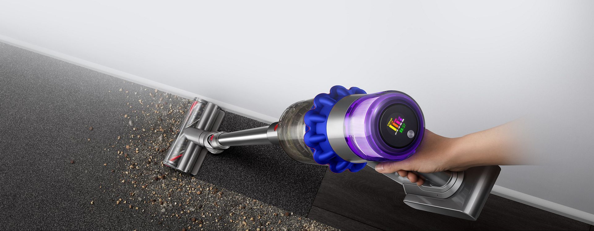 Overhead view of the Dyson V15 Detect vacuum with the Fluffy Optic cleaner head illuminating hidden dust.