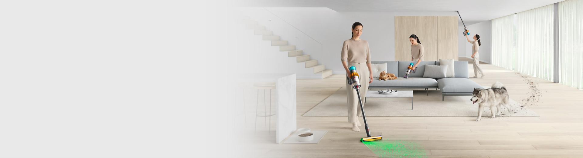 A woman cleaning different parts of a home with the Dyson V15 Detect vacuum and illuminating cleaner head.