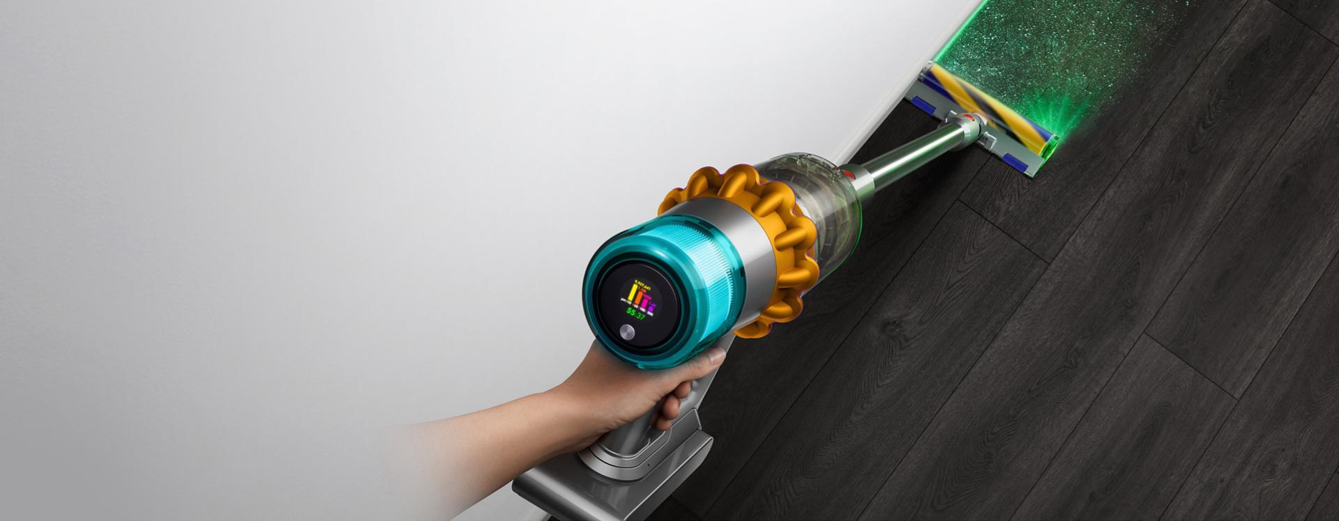 Overhead view of the Dyson V15 Detect vacuum with the Fluffy Optic cleaner head illuminating hidden dust.