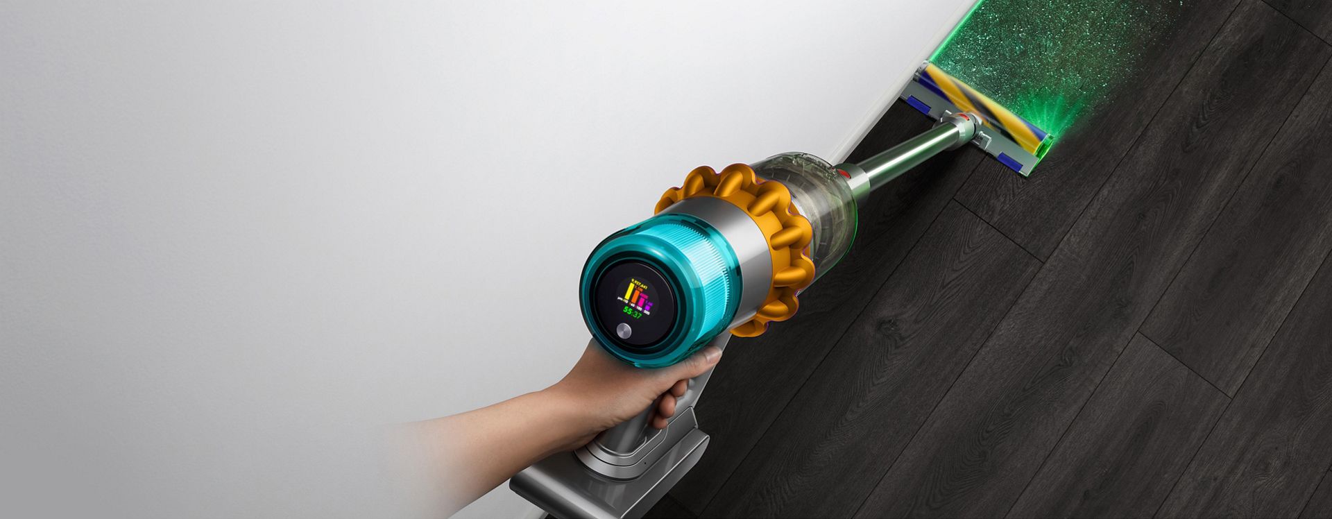 Overhead view of the Dyson V15 Detect vacuum with the Fluffy Optic cleaner head illuminating hidden dust.