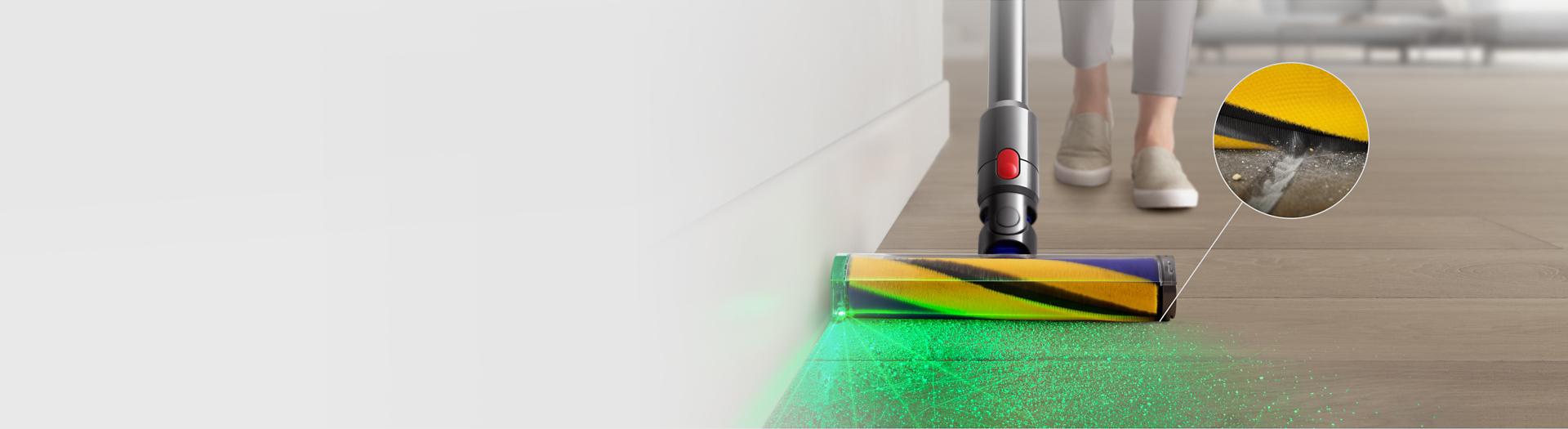 Front view of the Fluffy Optic cleaner head vacuuming and illuminating dust, with a close-up showing a crevice being cleaned.