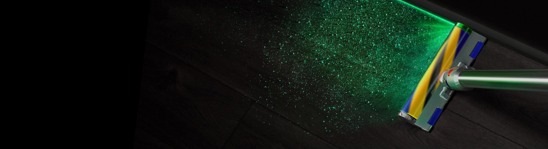 Overhead view of the Fluffy Optic cleaner head illuminating dust on hard floor.