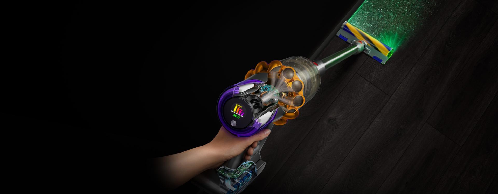 Overhead view of the Dyson V15 Detect vacuum with the Fluffy Optic cleaner head illuminating hidden dust.