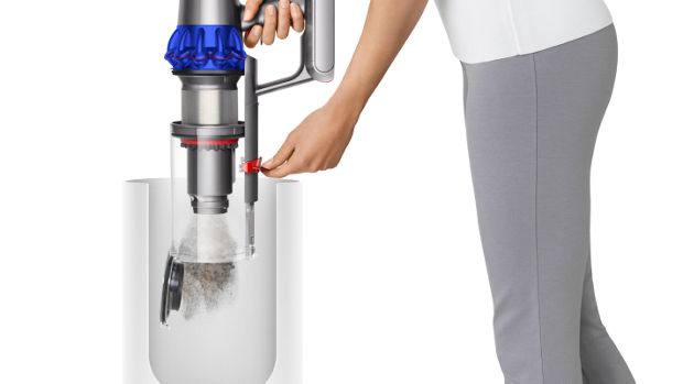 A woman empties the Dyson Gen5detect vacuum's bin in one action.