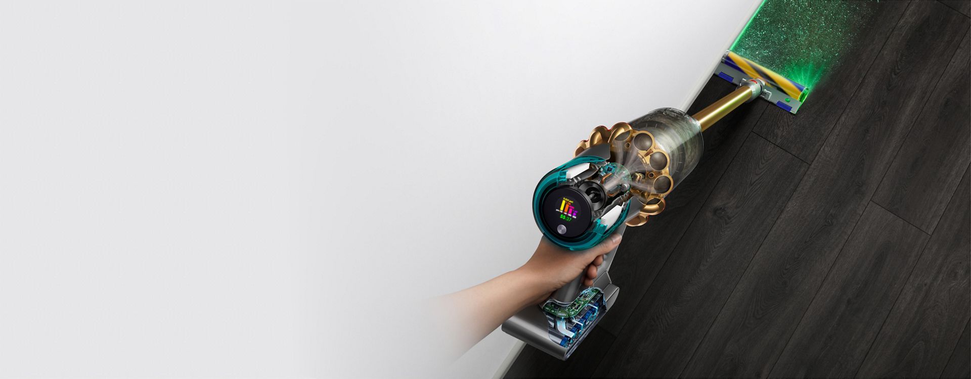 The Dyson V15s Detect Submarine wet and dry vacuum cleaner illuminates and cleans dust from a hard floor.