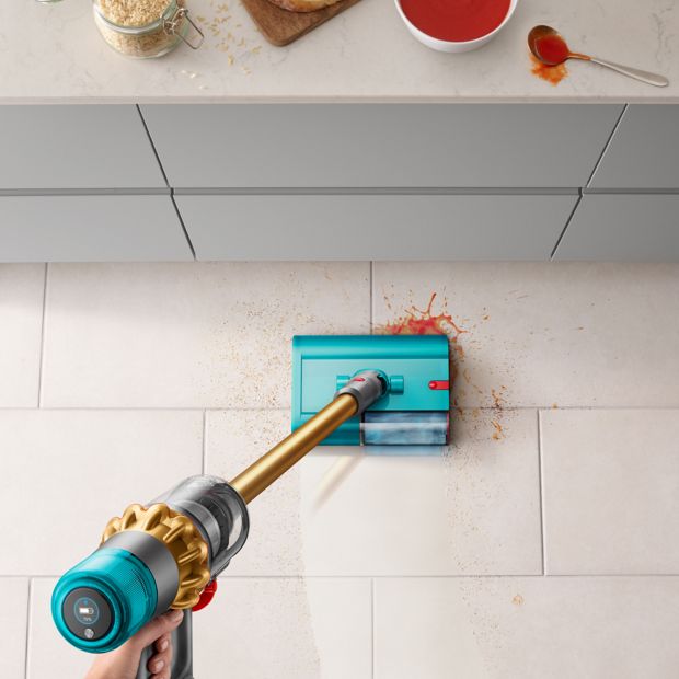 The Dyson V15s Detect Submarine cleans the floor of a kitchen.