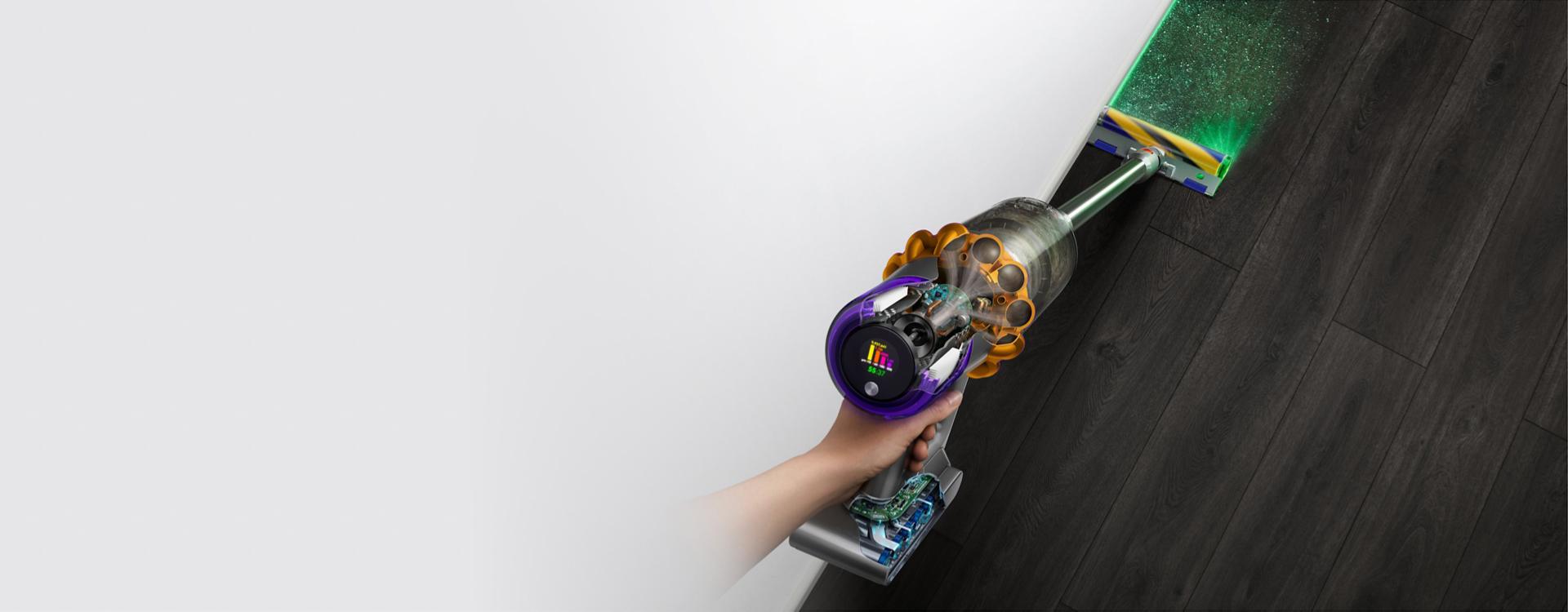 The Dyson V15s Detect Submarine wet and dry vacuum cleaner illuminates and cleans dust from a hard floor.