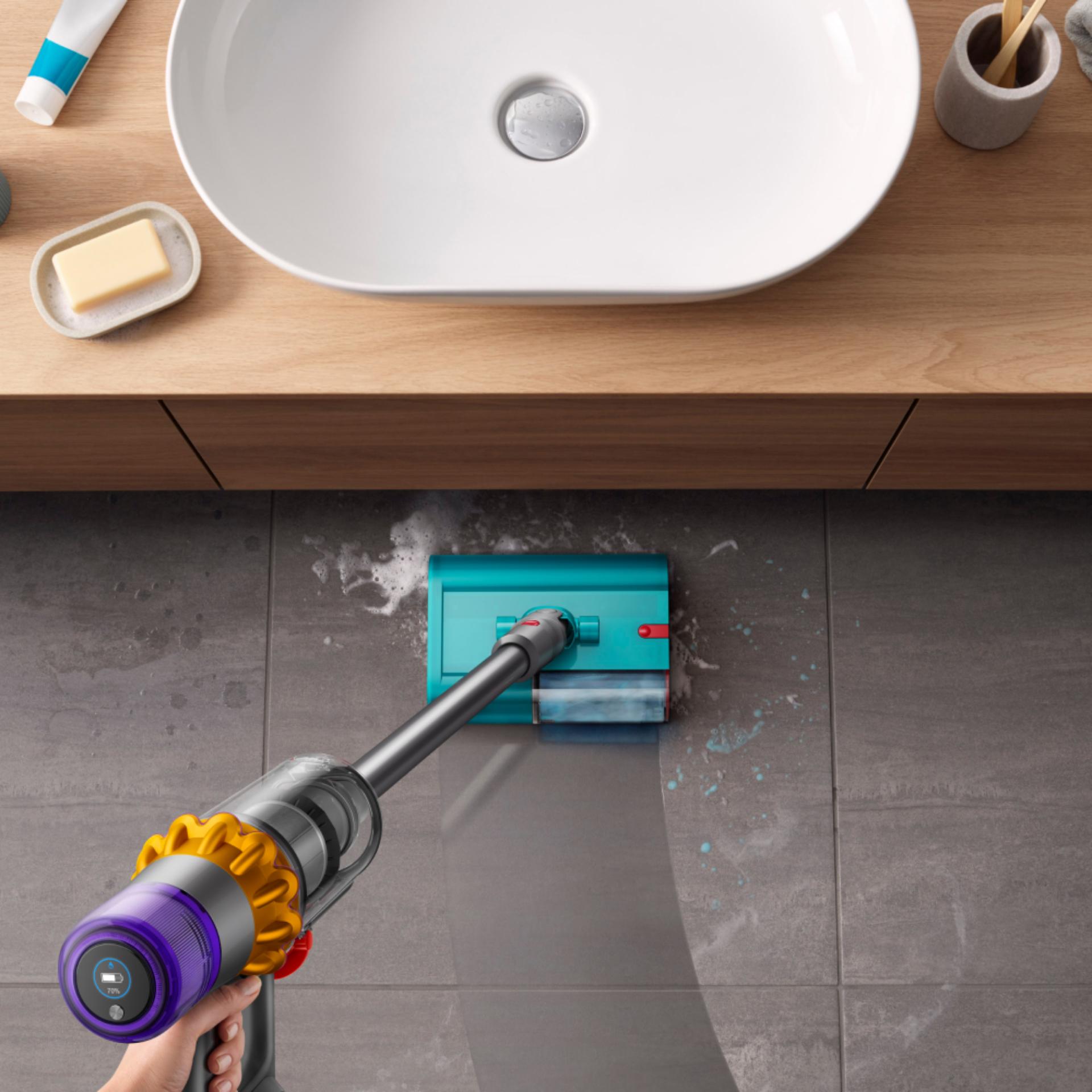 The Dyson V15s Detect Submarine cleans the floor of a bathroom.