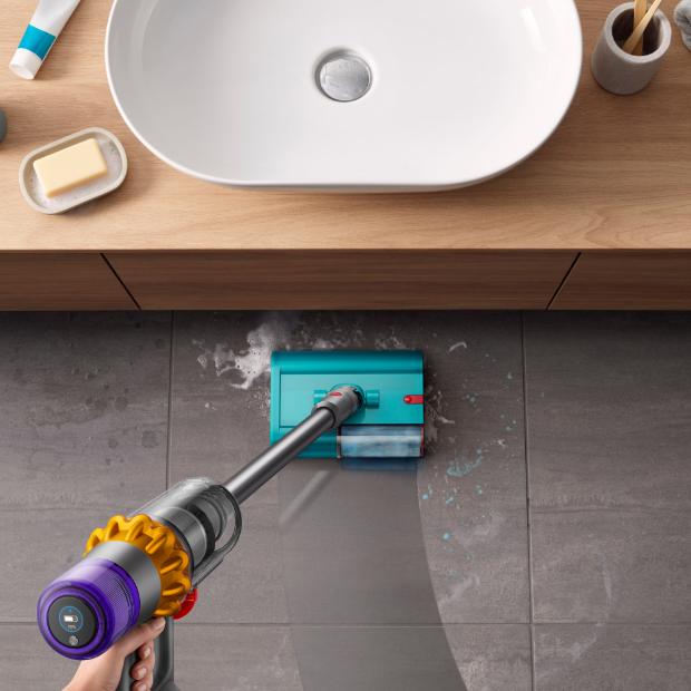 The Dyson V15s Detect Submarine cleans the floor of a bathroom.