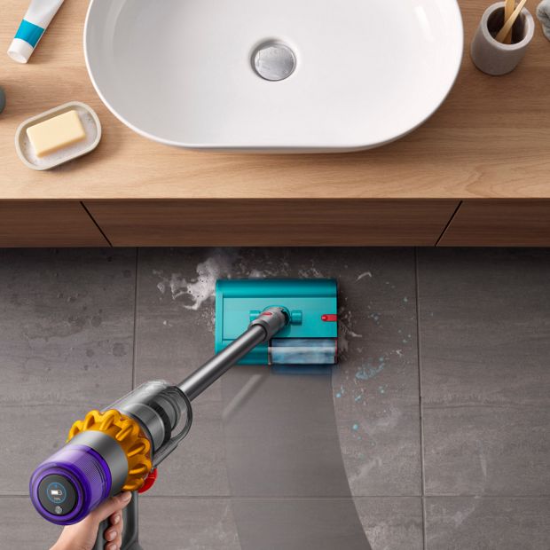 The Dyson V15s Detect Submarine cleans the floor of a bathroom.