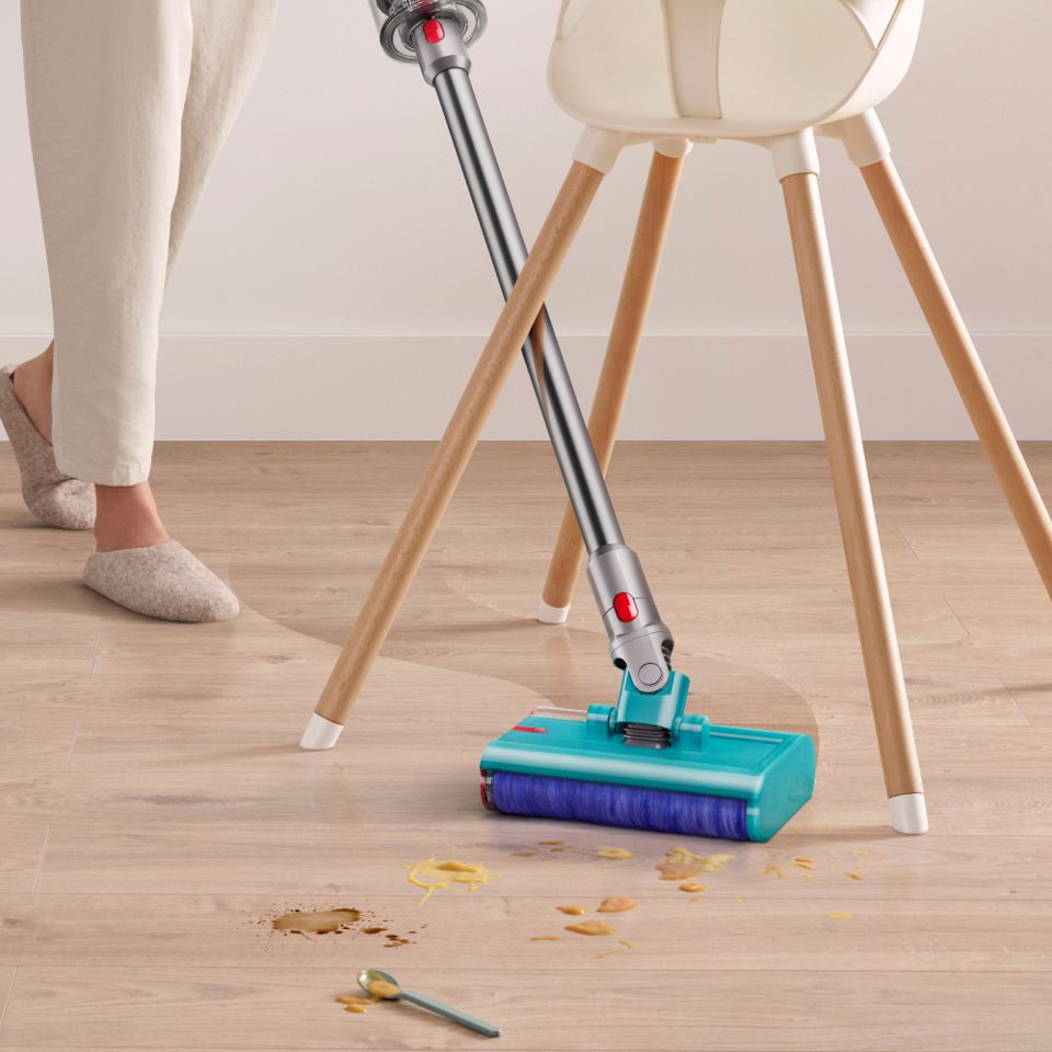 The Dyson V15s Detect Submarine cleans around the legs of a high chair.