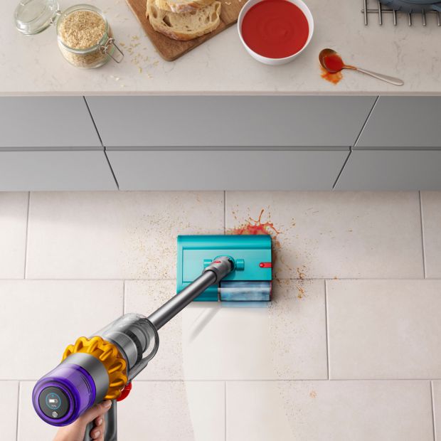 The Dyson V15s Detect Submarine cleans the floor of a kitchen.