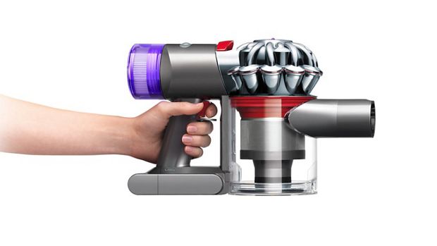Side view of the body of the Dyson V8 vacuum cleaning up high and down low.