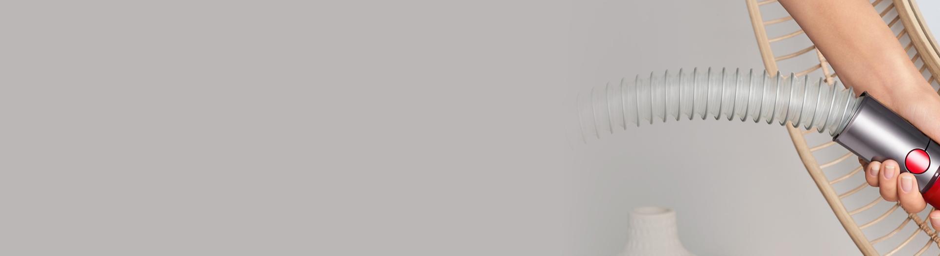 Extension hose adds extra reach to clean a wicker chair.