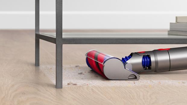 Close-up of the Slim Fluffy cleaner head vacuuming under furniture.