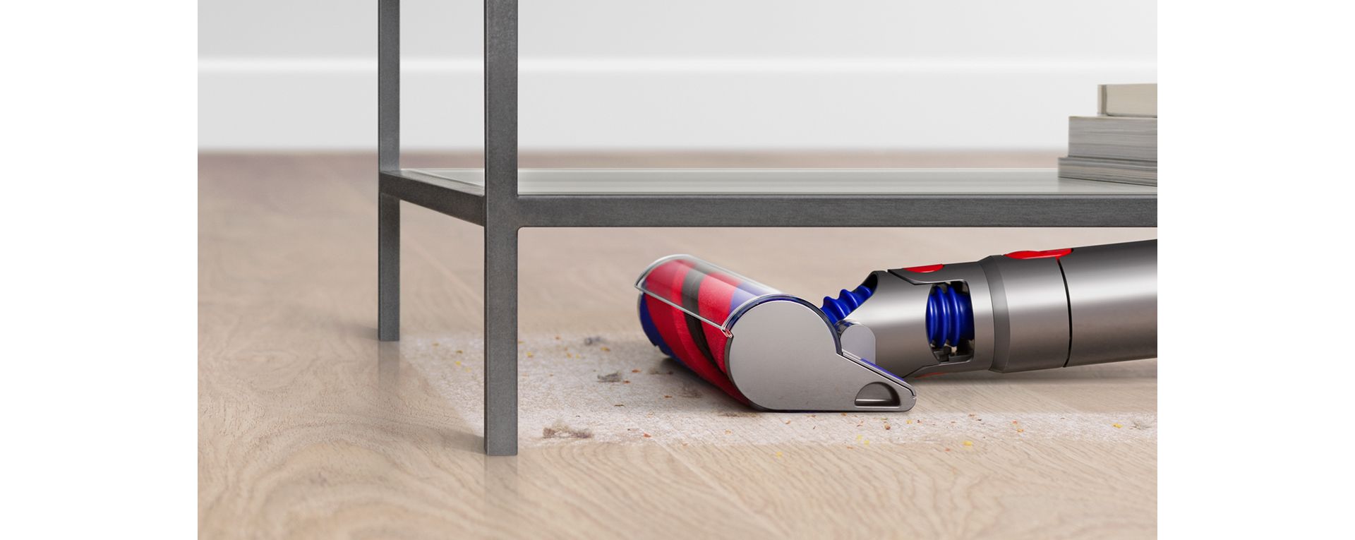 Close-up of the Slim Fluffy cleaner head vacuuming under furniture.