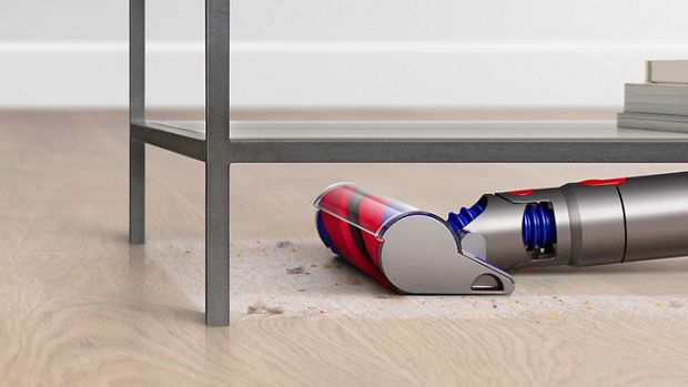 Close-up of the Slim Fluffy cleaner head vacuuming under furniture.
