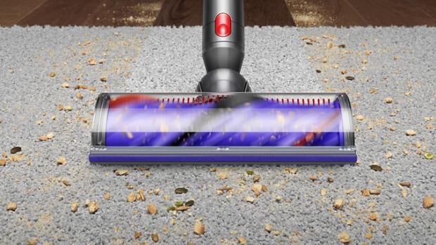 Cleaner head picking up dirt from carpet.