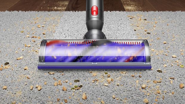 Cleaner head picking up dirt from carpet. 