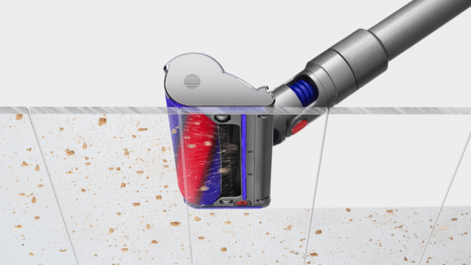 The Dyson V8 vacuum capturing the dust and debris at the same time