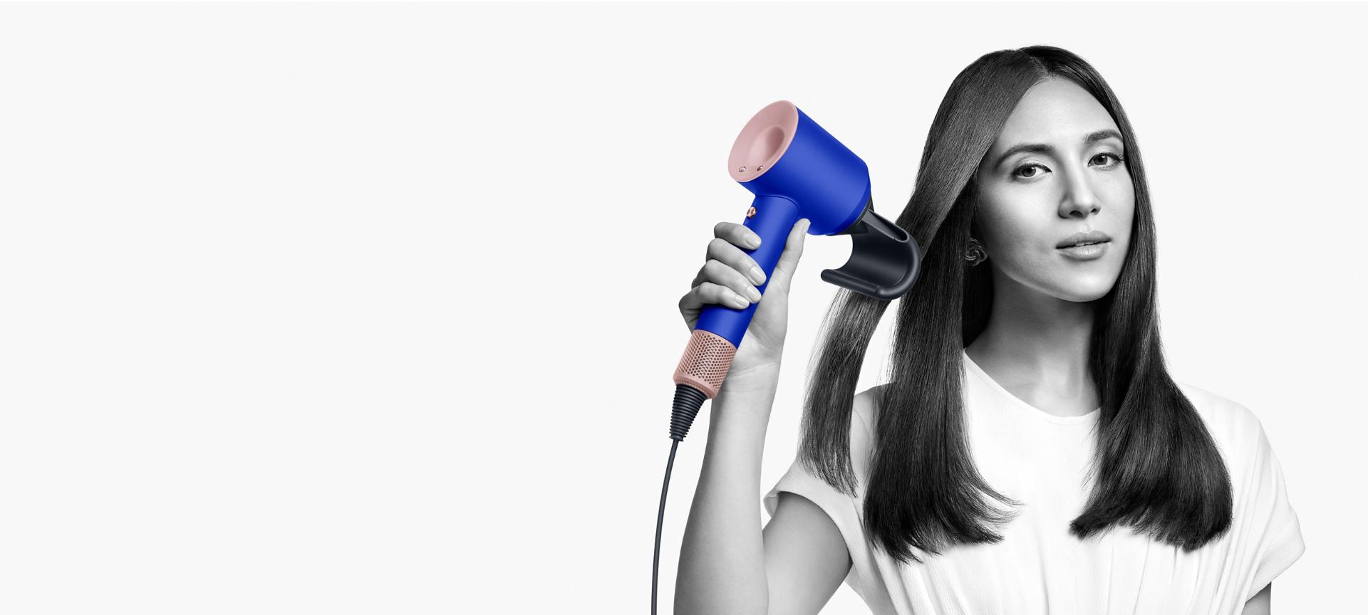 Model using a Dyson Supersonic in Blue Blush with the new Flyaway attachment