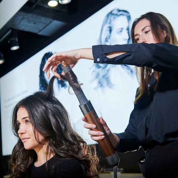 Woman trying out a Dyson Airwrap styler