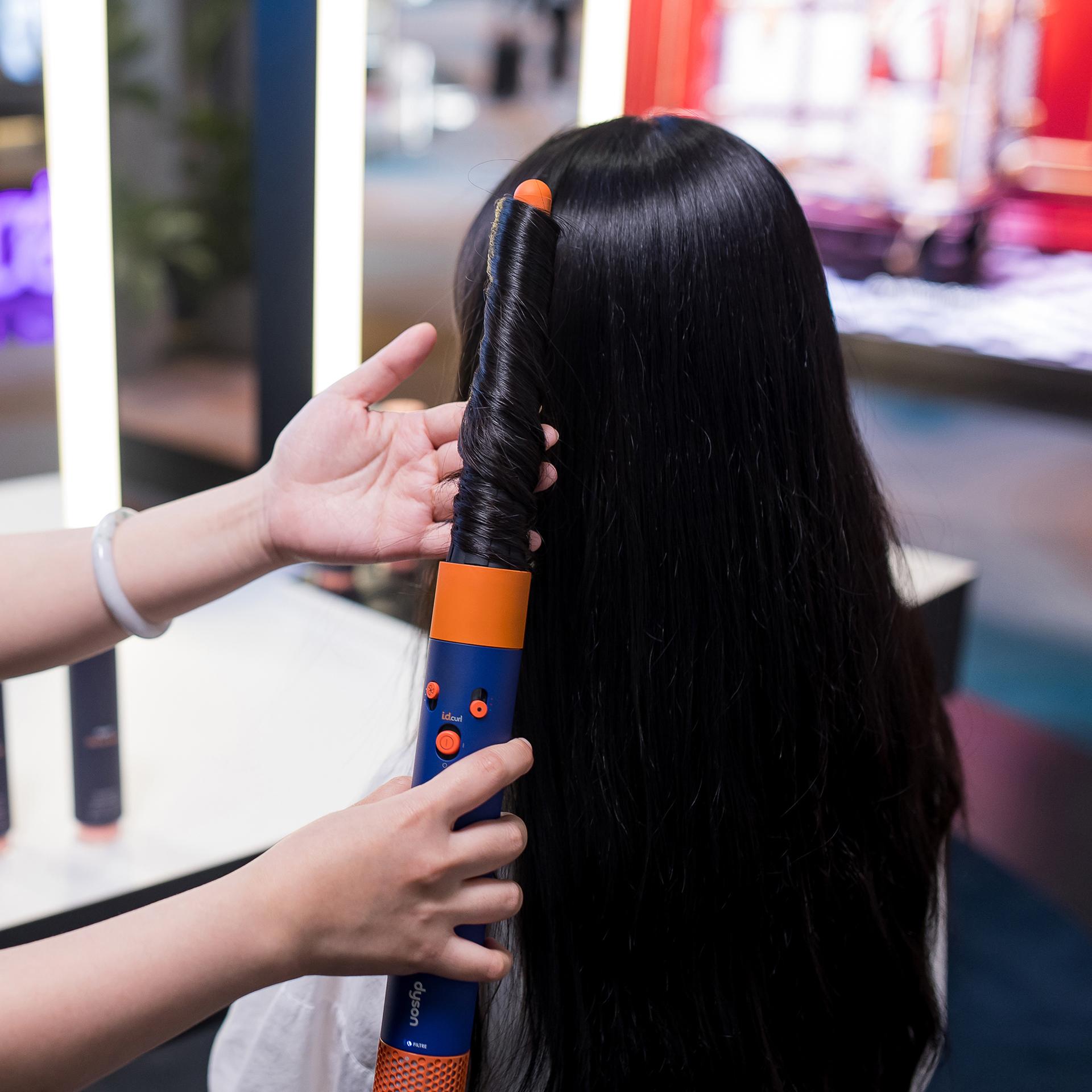 Woman trying out a Dyson Airwrap styler