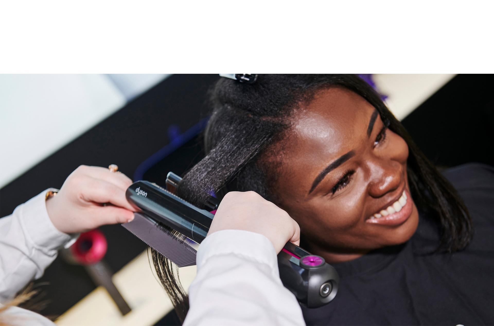 Dyson stylist helping someone with a demo
