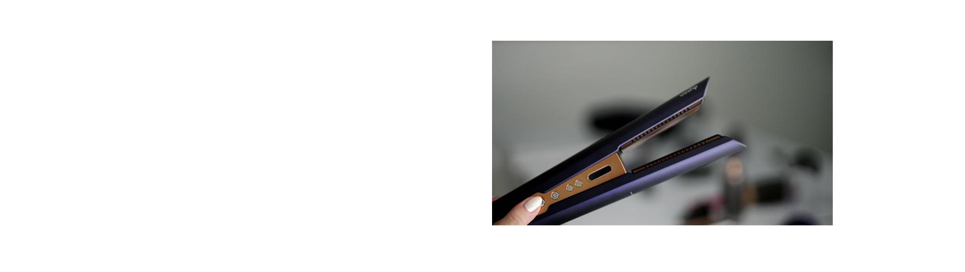 A close-up of a stylist using the Dyson Corrale straightener on a model