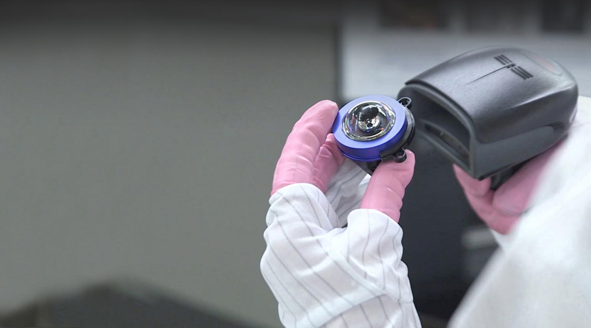 Engineer holding the eye from the Dyson Robot