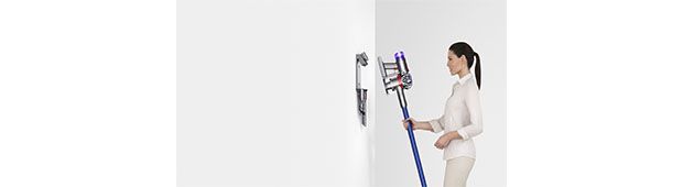Woman storing Dyson V8 vacuum in Wall Dok