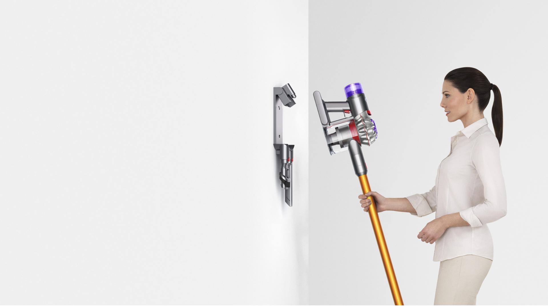Woman storing Dyson V8 vacuum in Wall Dok