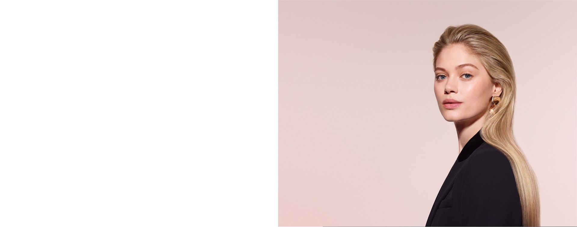 A model with blonde hair adds curls using the Dyson Airwrap Co-anda2x multi-styler and dryer.