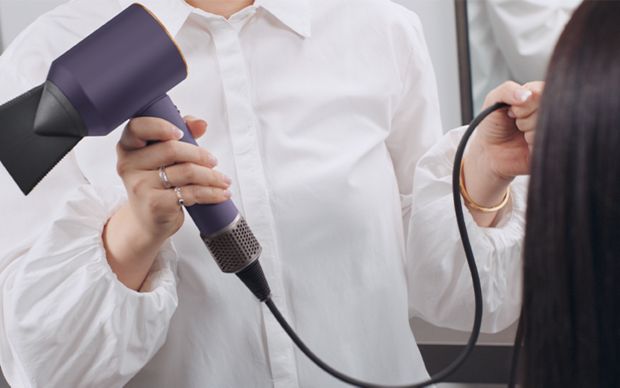 Jen Atkin showing the longer cord for the dyson Supersonic hair dryer