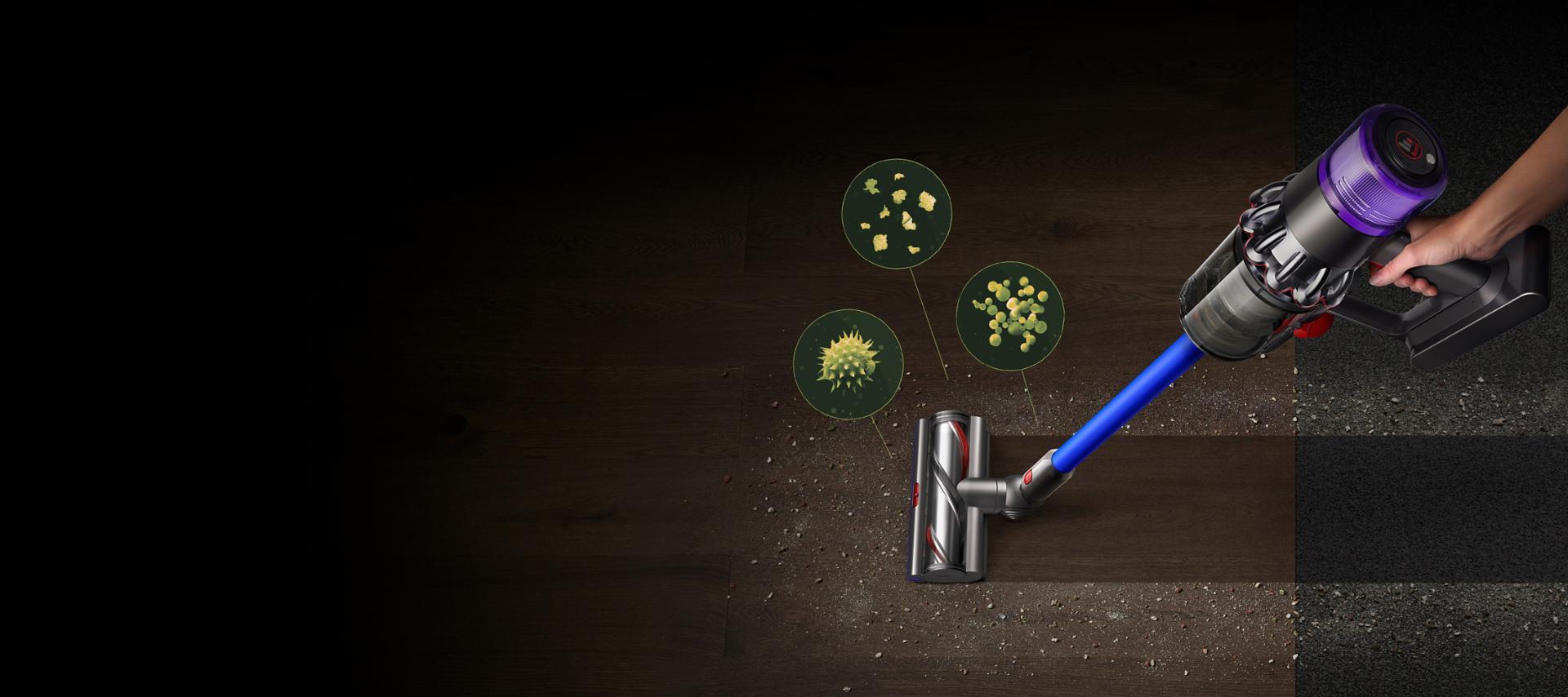 A Dyson V11™ vacuum picking up fine dust, allergens and pollen from the floor.