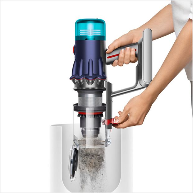 A person is emptying the bin of a V12s into the waste bin.