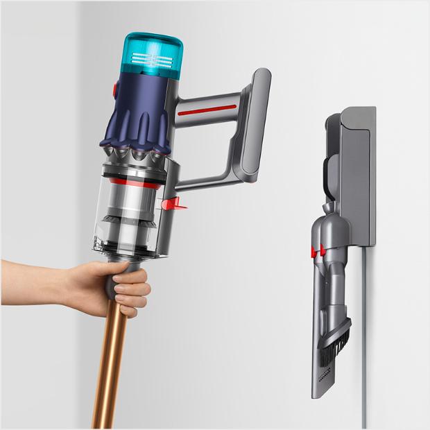 Vacuum being placed in its wall dock.