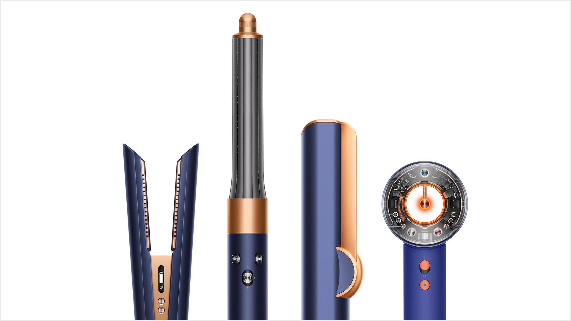 A line-up of Dyson hair care machines, in copper and nickel.