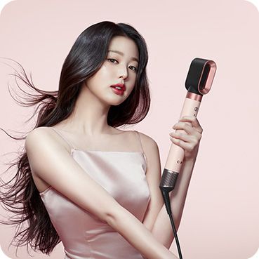The Dyson Airwrap Co-anda2x multi-styler and dryer with the Fast dryer 2x used by a dark-haired model to dry her long hair.