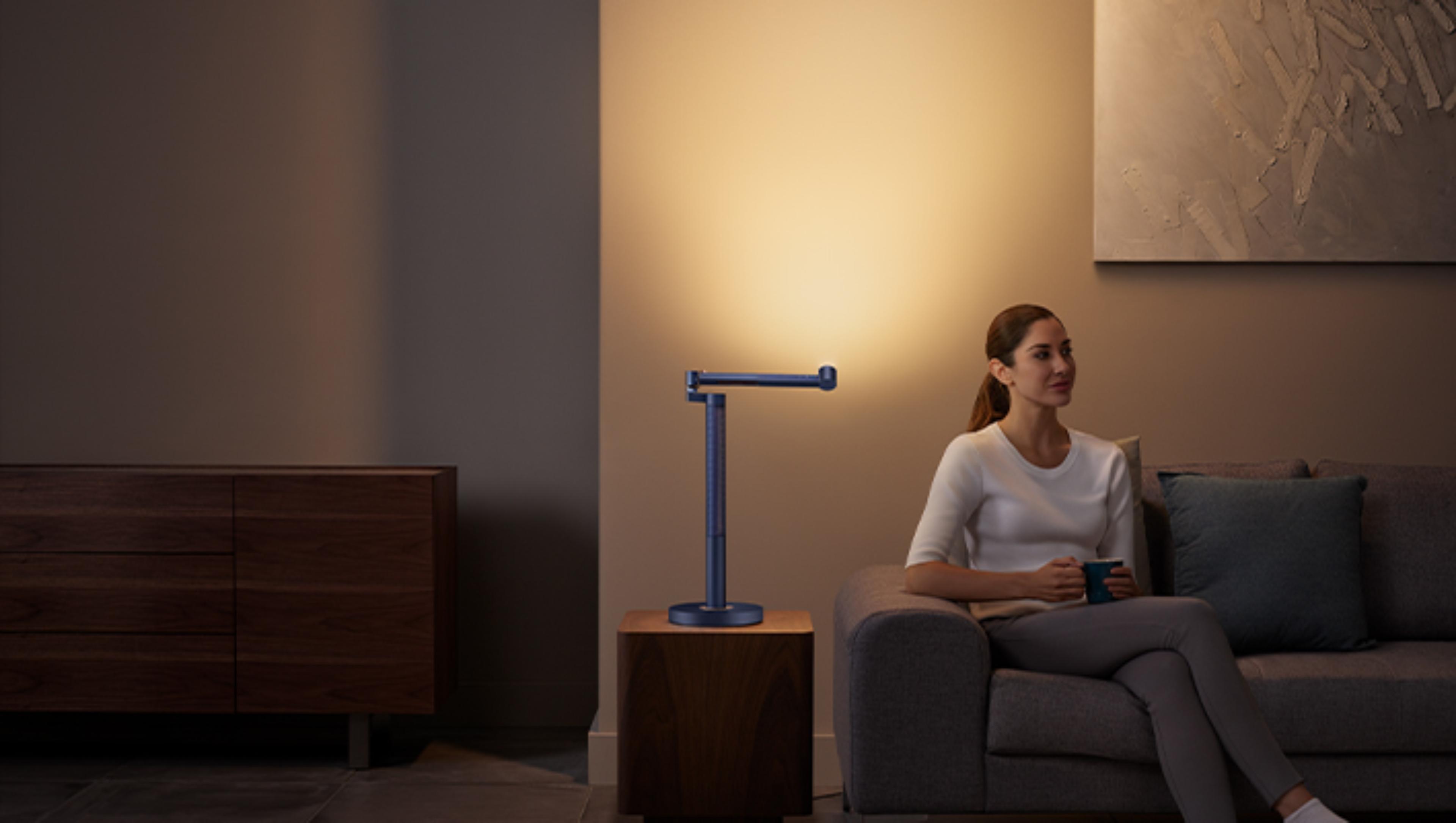 Woman working under the Dyson Lightcycle Morph light in Indirect position