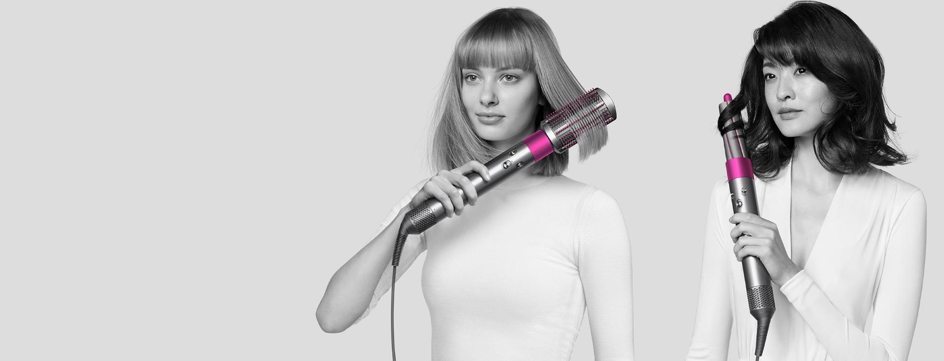 Two models styling their hair with the Dyson Airwrap hair styler