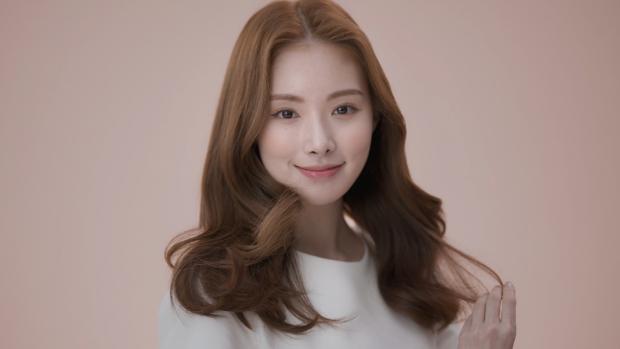 Model wearing a sleek side part style