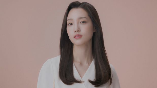 Model wearing a sleek side part style