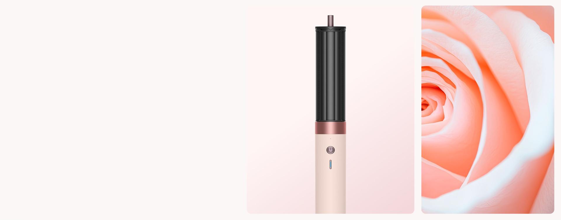 A blooming rose next to the Dyson Airwrap i.d. multi-styler and dryer in Ceramic pink and rose gold, and storage case.