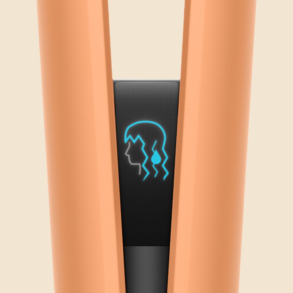A model styles hair with the Dyson Airstrait.