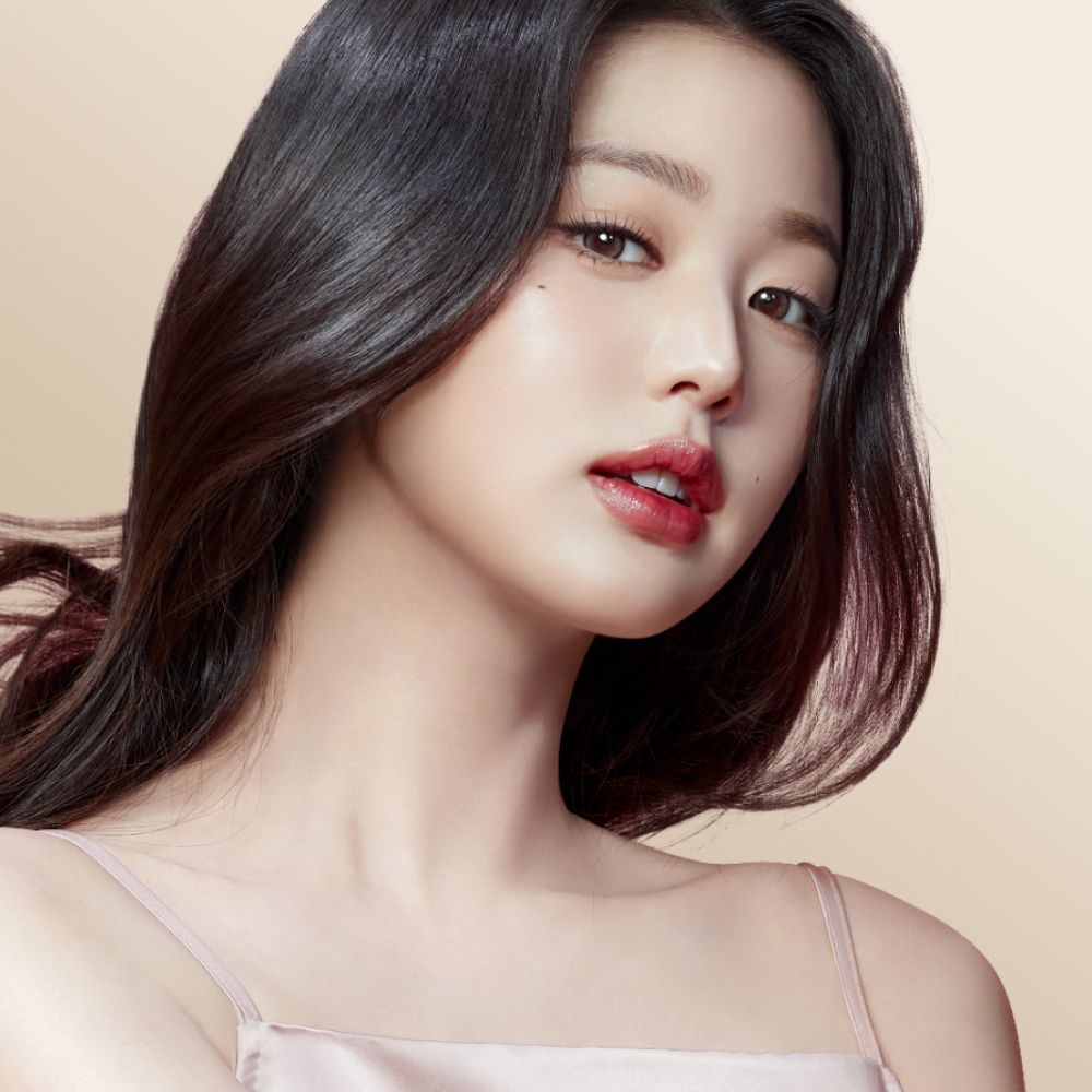 Model with long dark hair styled with the Dyson Supersonic Nural hair dryer.