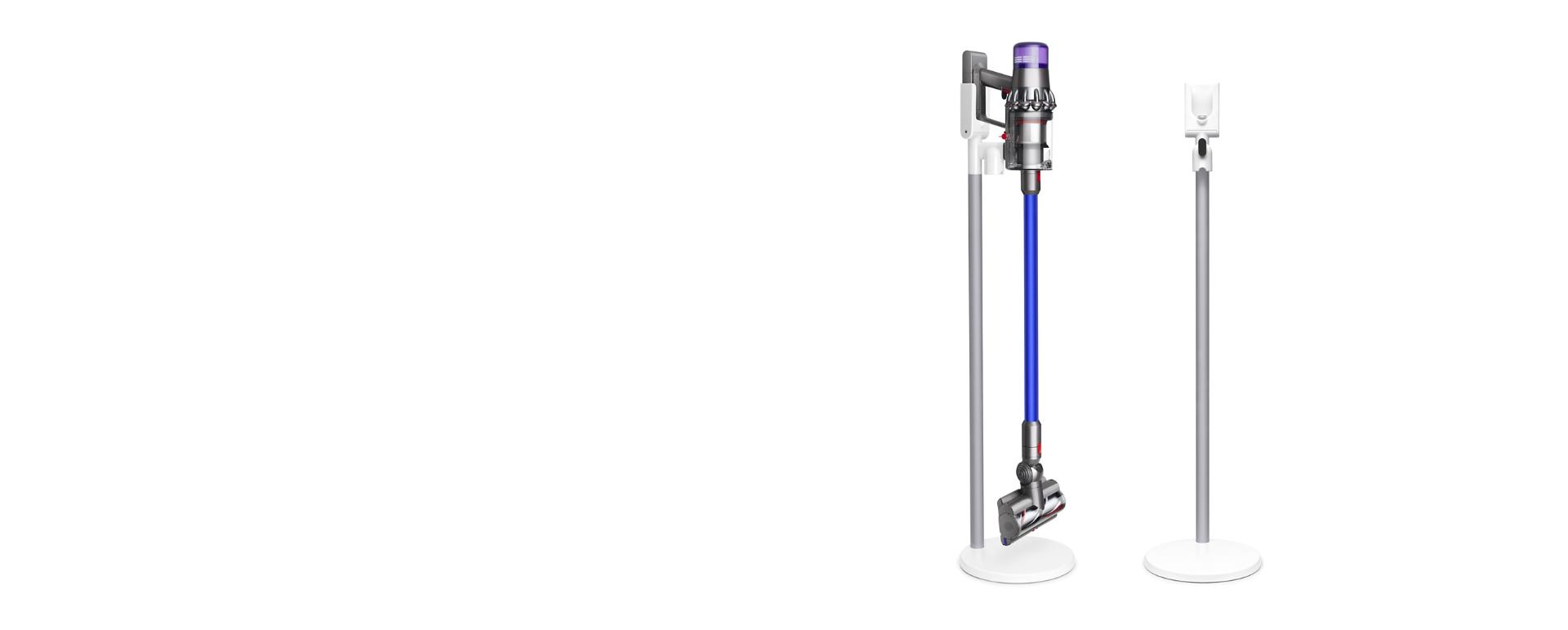 Woman placing Dyson V11™ vacuum into wall charging dock